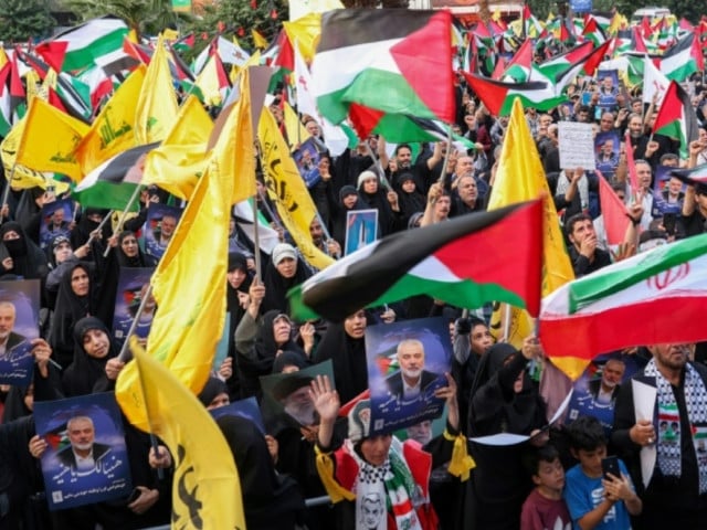 iranians wave palestinian flags and hold portraits of slain hamas leader ismail haniyeh at a protest denouncing his killing photo afp